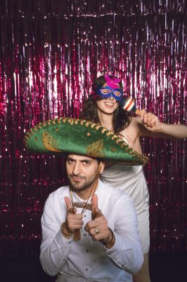medium-shot-friends-posing-together-photobooth